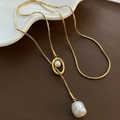 Golden snake chain necklace with baroque pearl pendant on dark leather background - Gold Sweater Chain (05-J23)