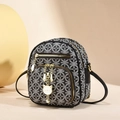 Chic black and white patterned crossbody bag with gold zippers and a cute cat pendant - Black