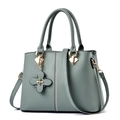 Elegant sage green crossbody bag with beaded details and flower charm in faux leather - Green