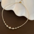 White mermaid shell pearl necklace with adjustable gold clasp on a ceramic tray - Graduated Pearl Necklace (1-3-22)