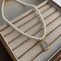 Elegant pearl necklace with a vintage golden rose pendant on a beige velvet jewelry box - Gold Rose Titanium Steel Glass Bead Necklace (xk-299)