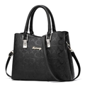 Elegant black faux leather handbag with embossed C-pattern and gold metal logo - Monogram-Embossed Black
