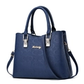 Dark blue large capacity tote bag with embossed pattern and gold metal hardware - Monogram-Embossed Royal Blue
