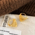 Detailed close-up of gold triangular earrings with intricate feather-like textures - Gold