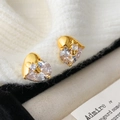 Macro shot of gold heart earrings with split-design clear cubic zirconia crystals - Gold