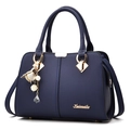 Dark blue pebbled leather handbag for women with gold hardware and floral charm decoration - Royal Blue