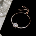 Detailed view of rose gold halo bracelet with round crystal on black velvet - Rose Gold