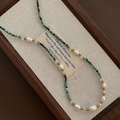 Baroque pearl necklace with turquoise beads and amethyst accents on jewelry box - Olive Green