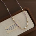 Baroque amethyst beaded necklace featuring white pearls and golden accent beads - Light Purple