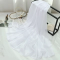Detail of pure white chiffon scarf with subtle shimmer on a white marble background - Bleached White