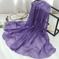 Close-up of lightweight dark purple scarf with subtle shimmer hanging on minimalist rack - Light Purple Blue