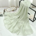 Close-up of light green chiffon scarf showing natural crinkle texture and neat hem - Light Green