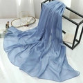 Detailed texture of light blue shimmer scarf with fine glitter on a display rack - Light Denim Blue