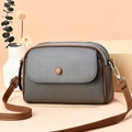 Mini gray pebbled leather crossbody bag with brown trim and double zipper compartments - Gray