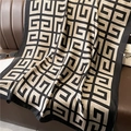 Detail of soft silk-texture scarf with geometric pattern on brown leather background - Black Beige Geometric (XL125-1)