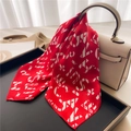 Elegant red satin silk scarf with geometric letters tied on a beige luxury handbag - Red Letter Print Style (FX-285)