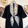 Detail of floral skinny silk scarf tied on a black sweater with lifestyle background - Light Blue Vintage Floral (LE-178)
