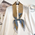 Detail of polka dot paisley silk scarf styled on a white shirt collar with accessories - Ginger Blue Floral Stripe (LE-187)