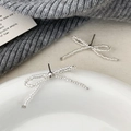 Detail of silver beaded bow earrings on a white plate with elegant knit background - Small Bowknot Stud Earrings