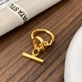 Detailed close-up of a shiny gold-plated T-bar hoop earring with a mirror-polished finish - Gold