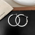 Dettaglio di orecchini a cerchio geometrici argento opaco con chiusura su sacchetto di lino - Argento 2cm x 30mm
