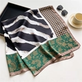 Detail view of zebra print and paisley silk scarf styled with sunglasses and coffee cup - Green Gold Paisley Zebra (FE123-1)