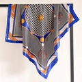 Detail view of houndstooth silk scarf with royal blue border and orange fringe patterns - Blue Border (FT246-1)