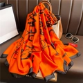 Luxurious orange silk scarf with black letter print draped over a stylish handbag - Orange Black Artistic Letter Style (XL100-2)