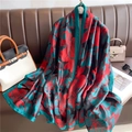 Detailed texture of gradient floral silk scarf draped elegantly on a leather sofa - Red Black Green Floral (XL132-1)