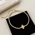 Detail eines Kleeblatt-Armbands in Gold mit Zirkonia auf schwarzem Samtkissen - Gold
