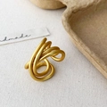 Macro detail of a minimalist multi-layer spiral ring with matte gold finish - Gold