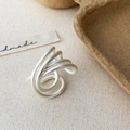Close-up of matte silver multi-layer winding ring showing elegant brushed metal texture - Silver
