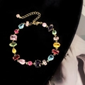 Bracciale Gema con gemme colorate di varie forme su una catena dorata elegante - Oro