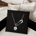 Detailed macro view of silver paperclip necklace with heart pendant and zircon inlay - Silver White Zircon Heart Necklace