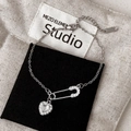 Macro shot of silver safety pin bracelet with zircon heart charm and lobster clasp - Silver White Zircon Heart Bracelet