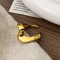 Detalle macro de anillo abierto dorado con diseño ondulado y acabado muy pulido - Dorado