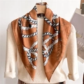 Detail of silk scarf with orange rope print tied elegantly on a cream knitted sweater - Caramel Rope Style (FR7-2)