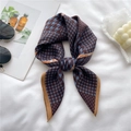 Elegant houndstooth silk scarf in navy and burgundy tied in a knot on white background - Blue Coffee