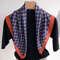 Navy blue and orange double-sided herringbone scarf with geometric pattern on a hanger - Blue/Orange Geometric (FR23-3)