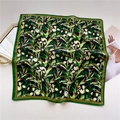 Detailed close-up of floral square scarf with green leaves and silky satin texture - Black Floral (FR31-2)