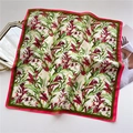 Detailed flat lay of floral square scarf with red tropical blooms and pink borders - Pink Green Tropical (FR31-4)