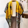 Detailed view of yellow floral silk scarf styled with beige knitwear and brown pleated skirt - 110X110CM / Yellow