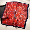 Close-up of elegant floral and wheel pattern on red and blue square silk scarf - Red (FJ720-2)