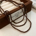 Long multilayer beaded necklace featuring cylinder tiger eye stones and dark brown beads - Brown Necklace