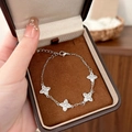Elegant silver clover bracelet with zircon stones displayed in a luxury jewelry box - Silver Bracelet