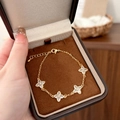 Elegant gold four-leaf clover bracelet with zircon crystals in a premium jewelry box - Gold Bracelet