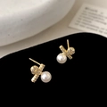 Macro shot of gold pearl stud earrings with zircon-encrusted cross design on black velvet - 4mm / Gold