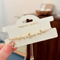 Detail of adjustable gold butterfly bracelet featuring white shell inlay and zircon stones - Gold Butterfly Bracelet