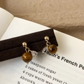 Detail of vintage gold earrings with tiger eye beads and teardrop zircon on a dark plate - Tiger Eye Stone Stud Earrings