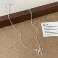Elegant silver bow pendant necklace with dainty chain accents on a modern minimalist backdrop - Silver Bow Necklace